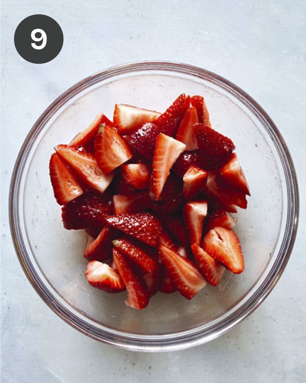 Strawberry ingredients for strawberry shortcake in a bowl mixed together.