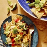 Taco salad served on a plate with a fork on the plate.
