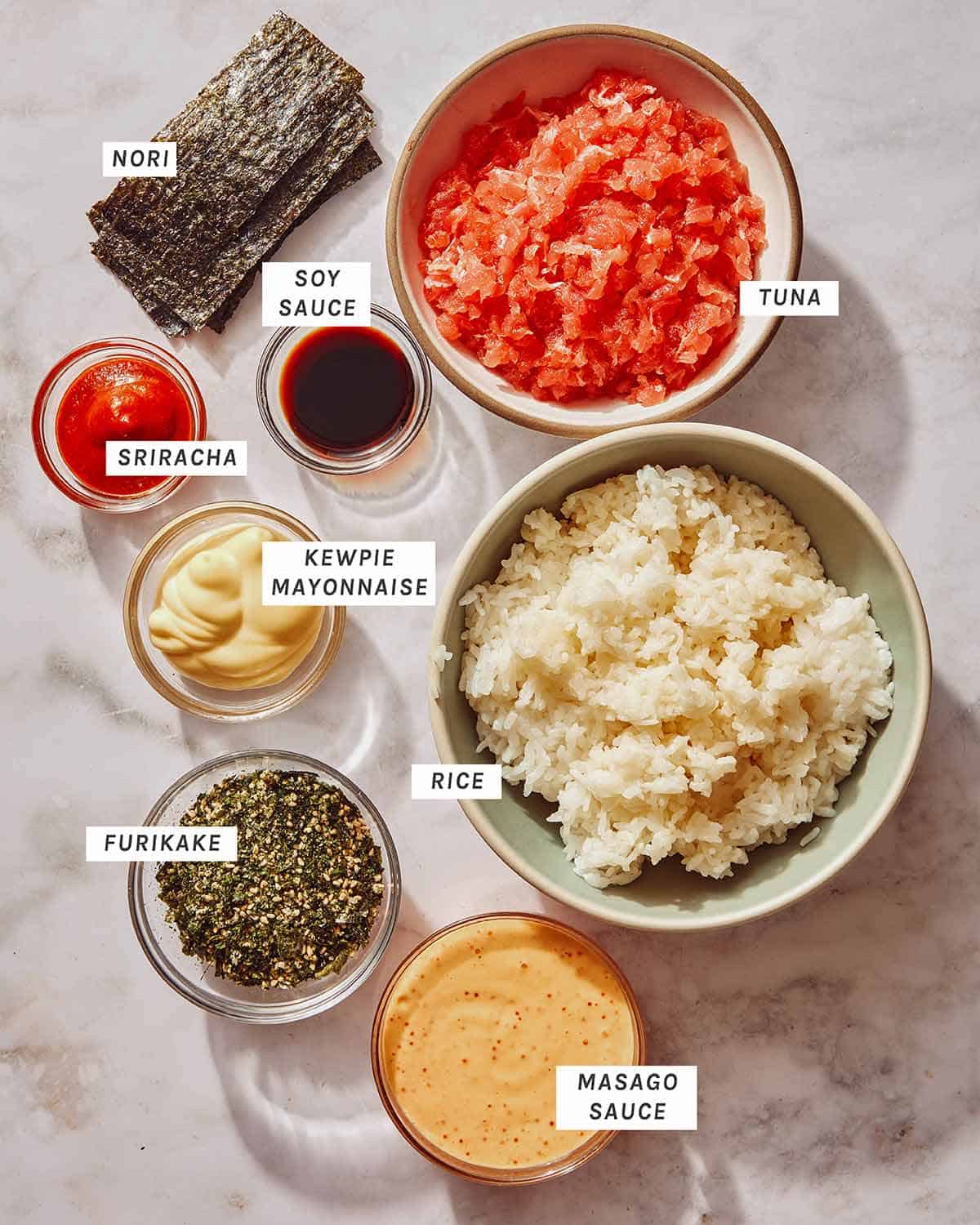 Spicy tuna onigiri ingredients on a kitchen counter.