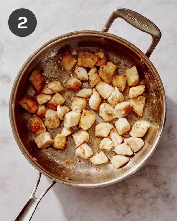 Searing chicken in a skillet to make tuscan chicken pasta. 