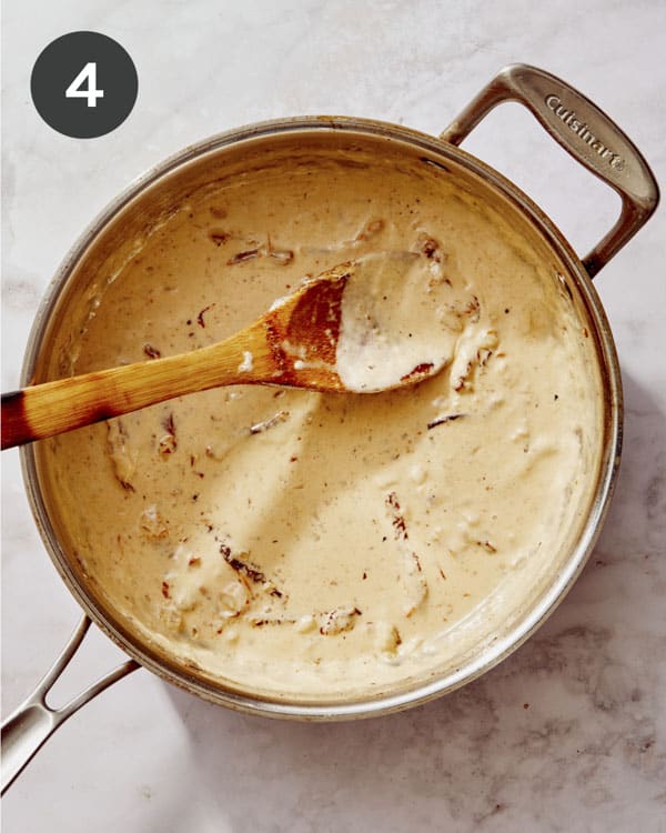 Tuscan chicken pasta sauce simmering in a skillet. 