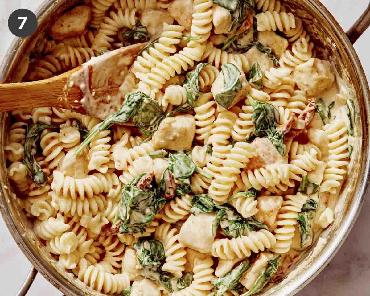 Tuscan chicken pasta in a skillet freshly made. 