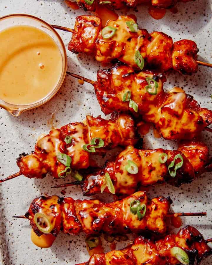 Air fryer bang bang chicken skewers on a platter.