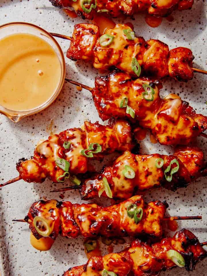 Air fryer bang bang chicken skewers on a platter.