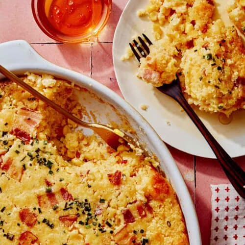 Corn casserole recipe with some scooped out on a plate.