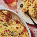 Corn casserole recipe with some scooped out on a plate.
