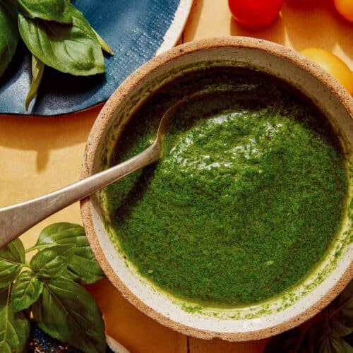 Basil vinaigrette recipe in a bowl ready to be drizzled on a salad.