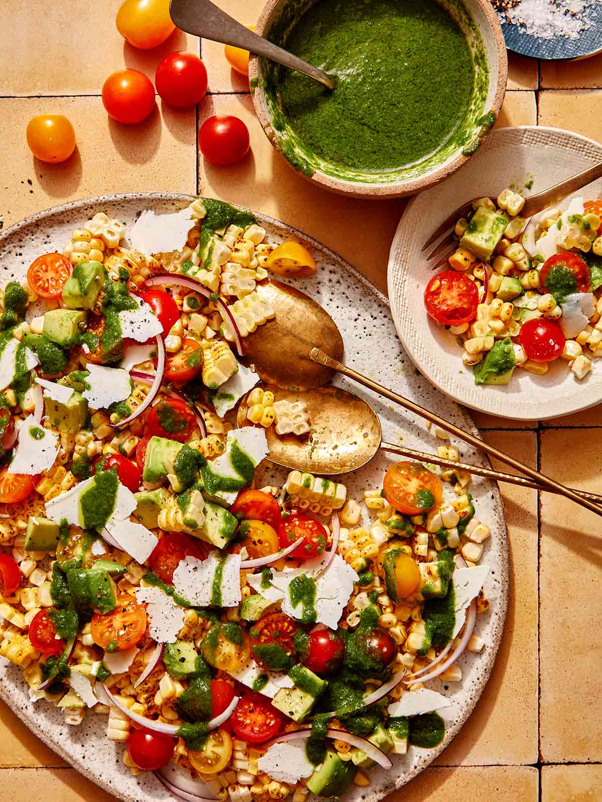 Corn salad being served onto a plate. 