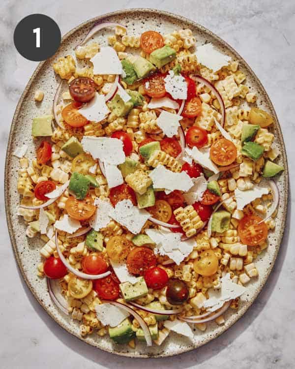 Summer corn salad recipe on a platter without dressing. 