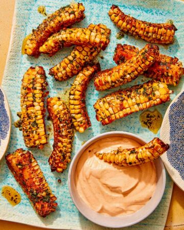 Corn ribs recipe on a platter with a dipping sauce.