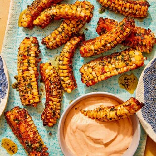 Corn ribs recipe on a platter with a dipping sauce.