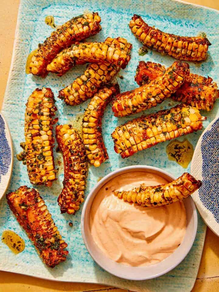 Corn ribs recipe on a platter with a dipping sauce.