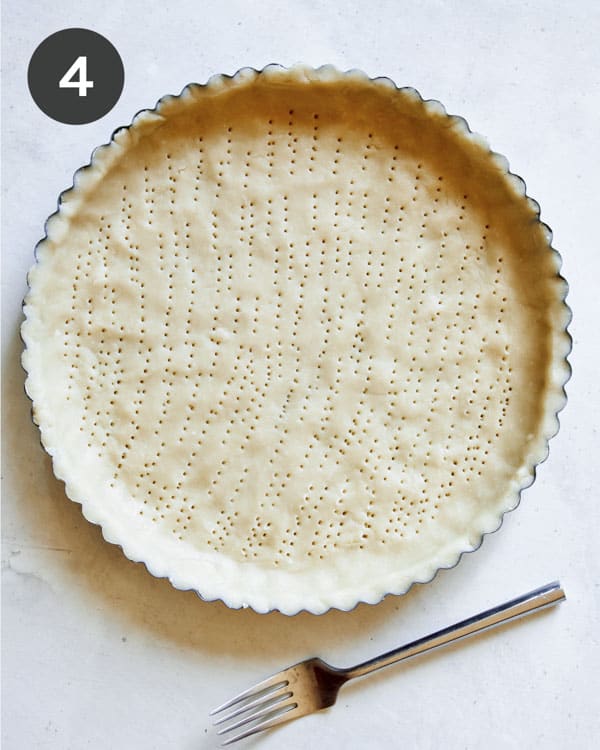 Tart dough pressed into a shell and pricked with a fork.