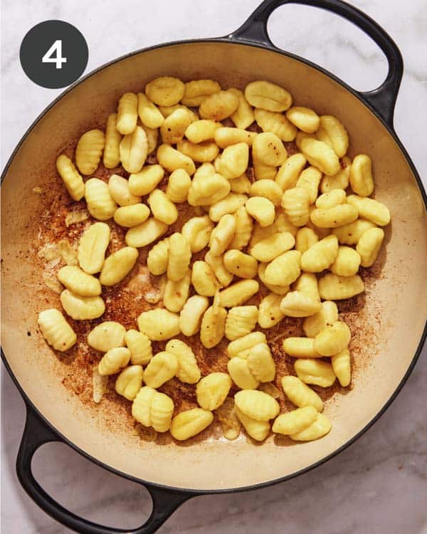Gnocchi searing in a skillet.