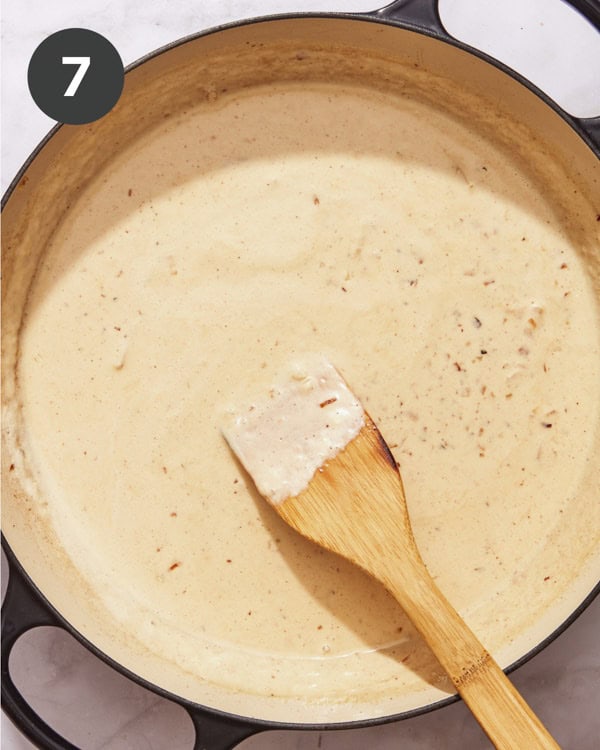 Cream sauce simmering to make baked gnocchi.