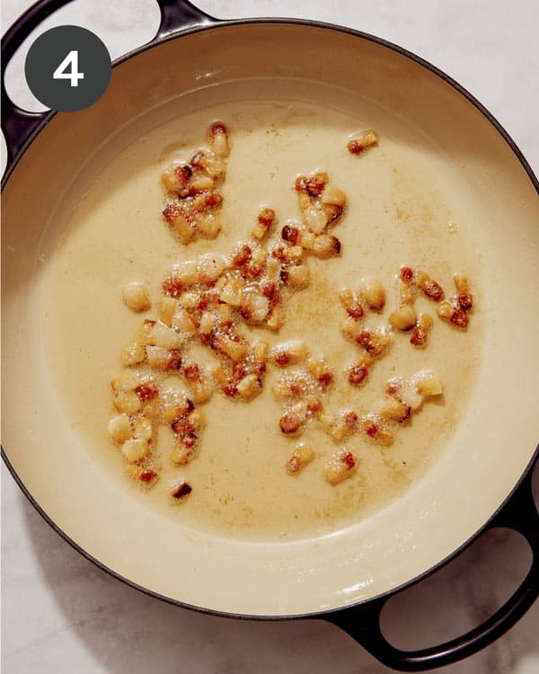 Guanciale being cooked in a skillet.