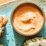 Masago sauce in a ramekin with onigiri on the side.