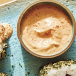 Masago sauce in a ramekin with onigiri on the side.