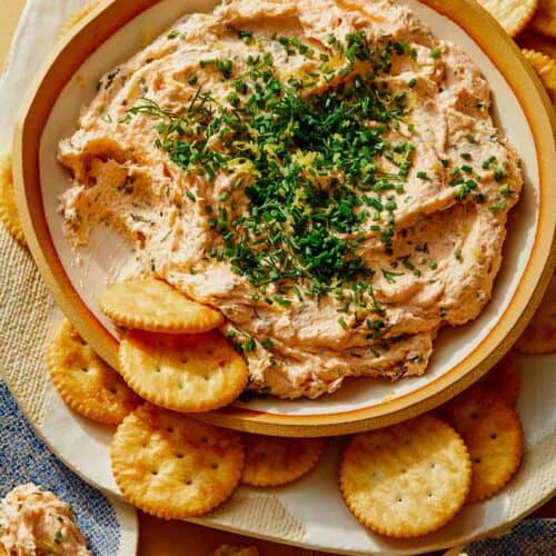 Smoked Salmon Dip recipe in a bowl with crackers on the side.