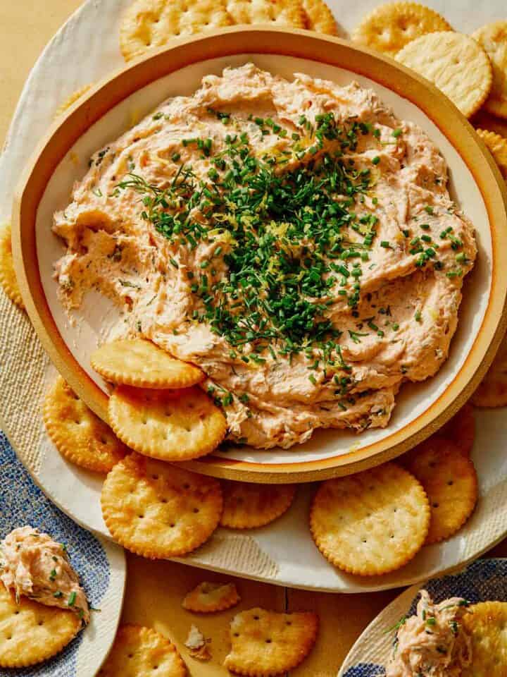 Smoked Salmon Dip recipe in a bowl with crackers on the side.