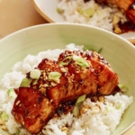 Soy glazed salmon on a bed of rice with a fork.
