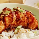 Hasselback salmon with a soy glaze recipe in two bowls with rice.