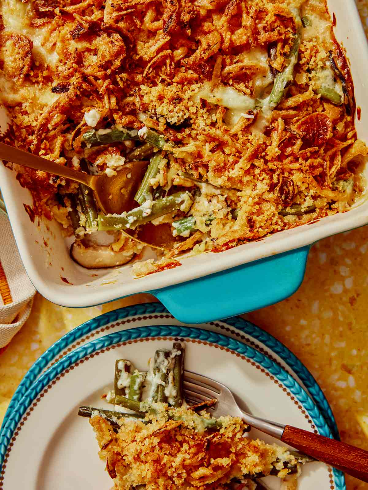 Green bean casserole with a scoop out on a plate.