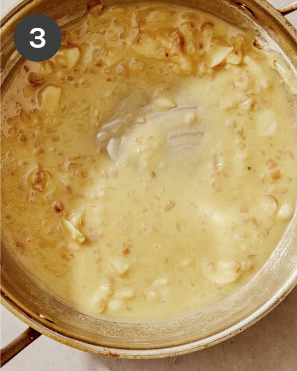 Green bean casserole sauce being cooked in a skillet.