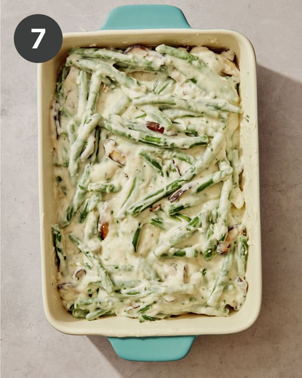 Green bean casserole in a casserole dish ready to be baked.