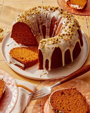 Pumpkin cake with a pistachio glazed cut with slices.