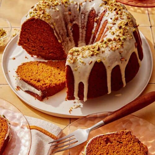 Pumpkin cake with a pistachio glazed cut with slices.