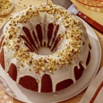 Pumpkin cake with a pistachio glaze on a serving platter.