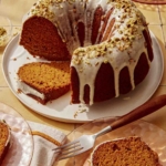Pumpkin cake with a pistachio glazed cut with slices.