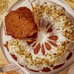 Pumpkin cake with some cut into slices.