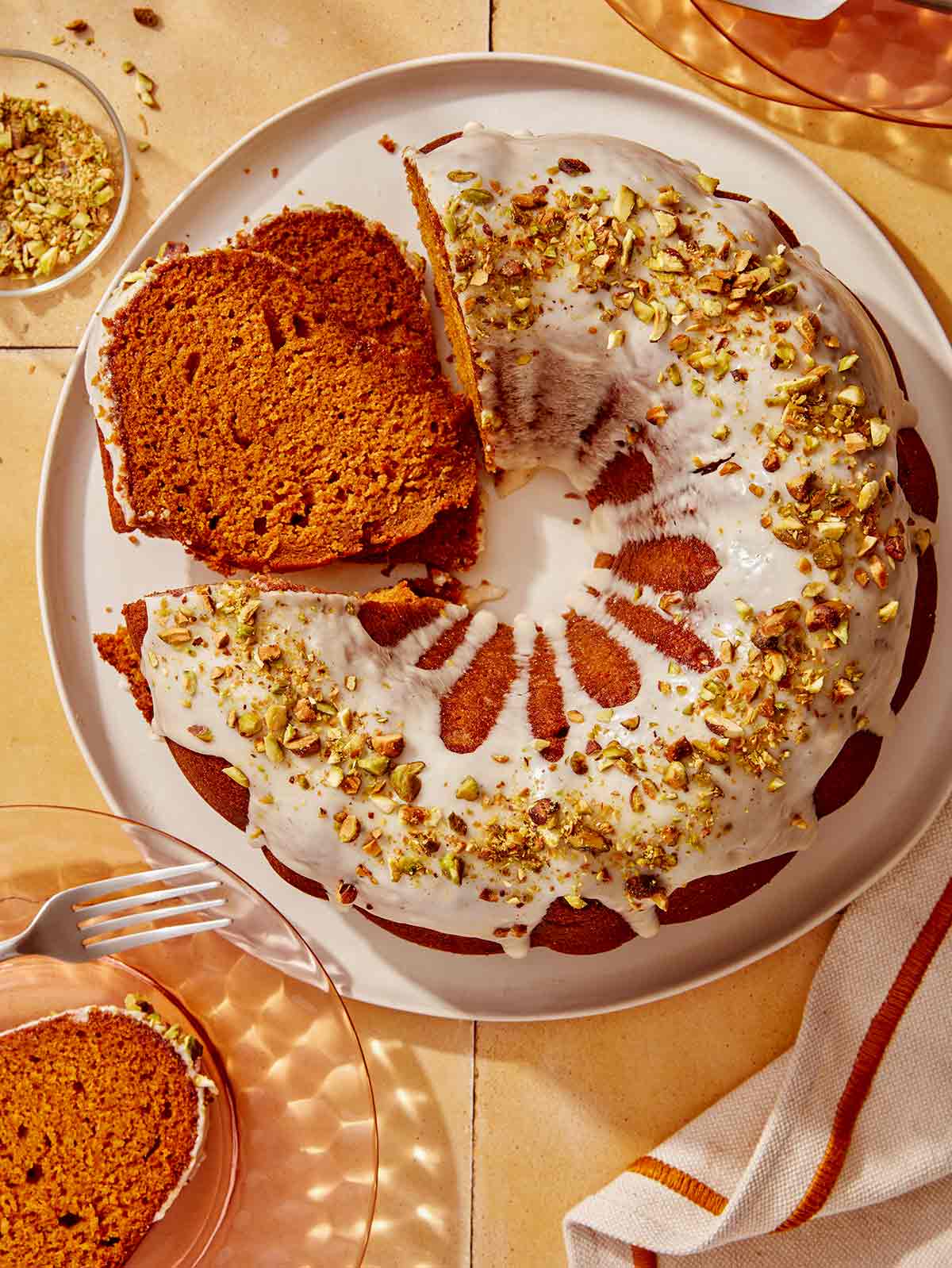 Pumpkin cake with some cut into slices.