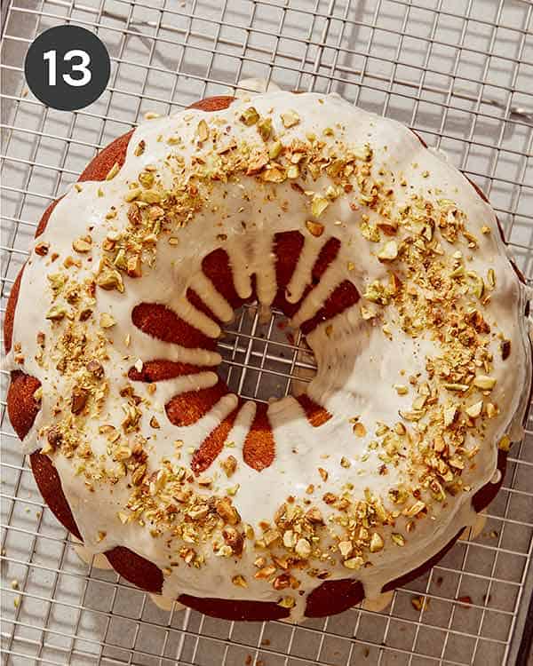 Pumpkin cake with glaze on top and crushed pistachios.
