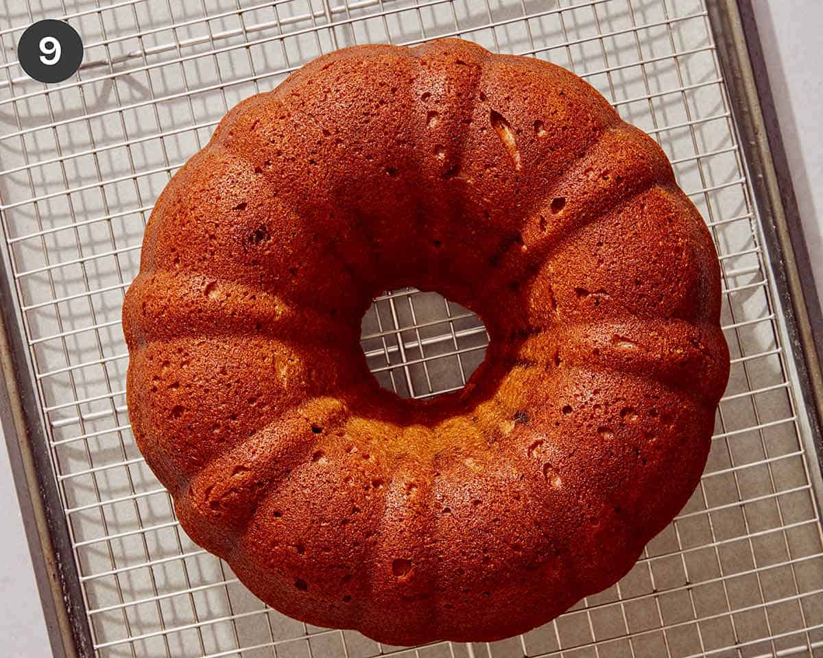 Pumpkin cake resting on a cooling rack.