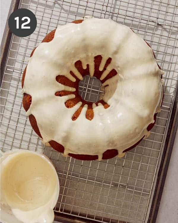 Pistachio glaze being poured onto a pumpkin cake.