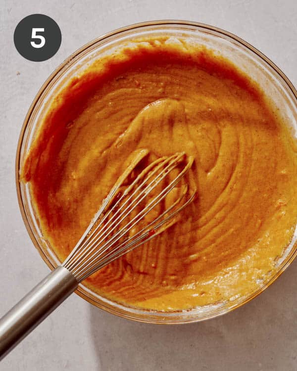 Pumpkin cake batter being mixed together.