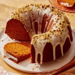 Pumpkin cake with a pistachio glazed cut with slices.
