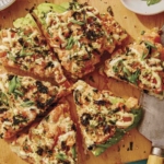 Sushi pizza recipe on a cutting board.