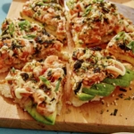 Sushi pizza cut into slices.