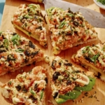 Sushi pizza cut into slices.