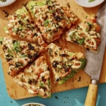 Sushi pizza recipe on a cutting board.