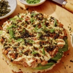 Sushi pizza on a cutting board.
