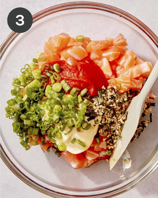 Spicy salmon ingredients in a glass bowl.