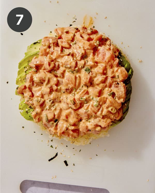 Sushi pizza with salmon on top.