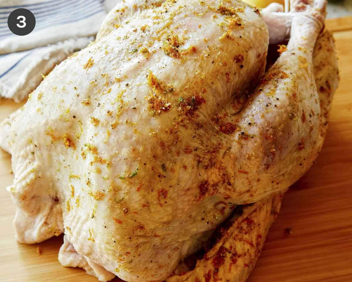 A raw turkey covered in citrus dry brine.