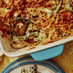 Close up on a green bean casserole with a serving taken out of it.
