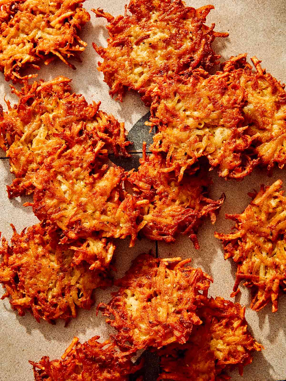 Close up on potato latkes with crispy edges.